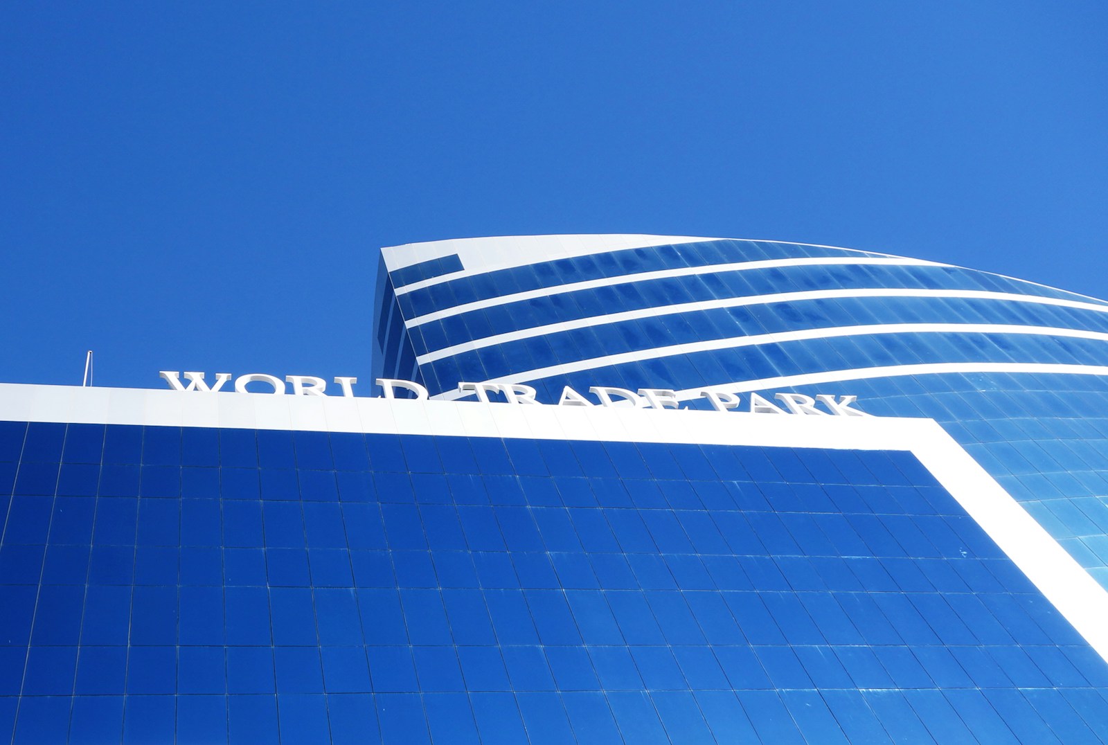 white and blue concrete building under blue sky during daytime