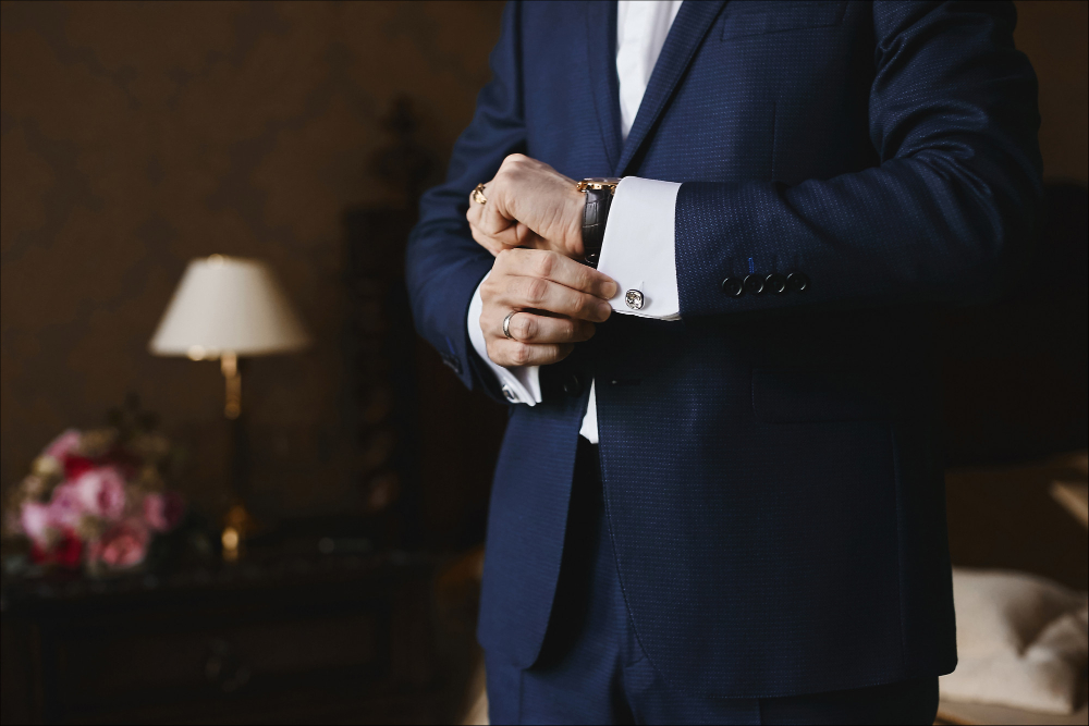 Photo close view of the luxury watches on the hand of a businessman in a suit and in a shirt with cufflinks.
