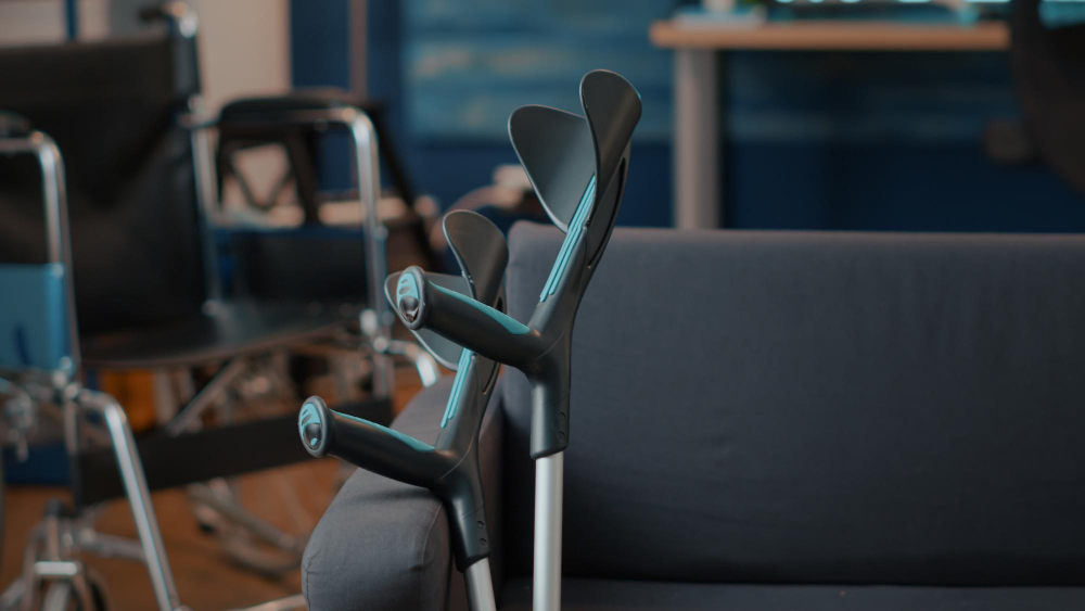 Crutches on empty couch in living room to give mobility support to people with chronic disability or injury. walking sticks helping with transportation and physical accessibility. walk crutch
