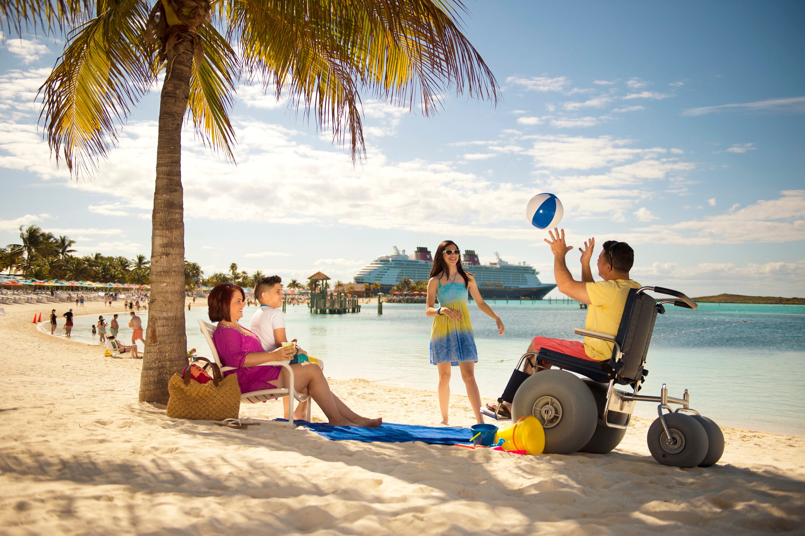 Family on beach with cruise ship in the distance