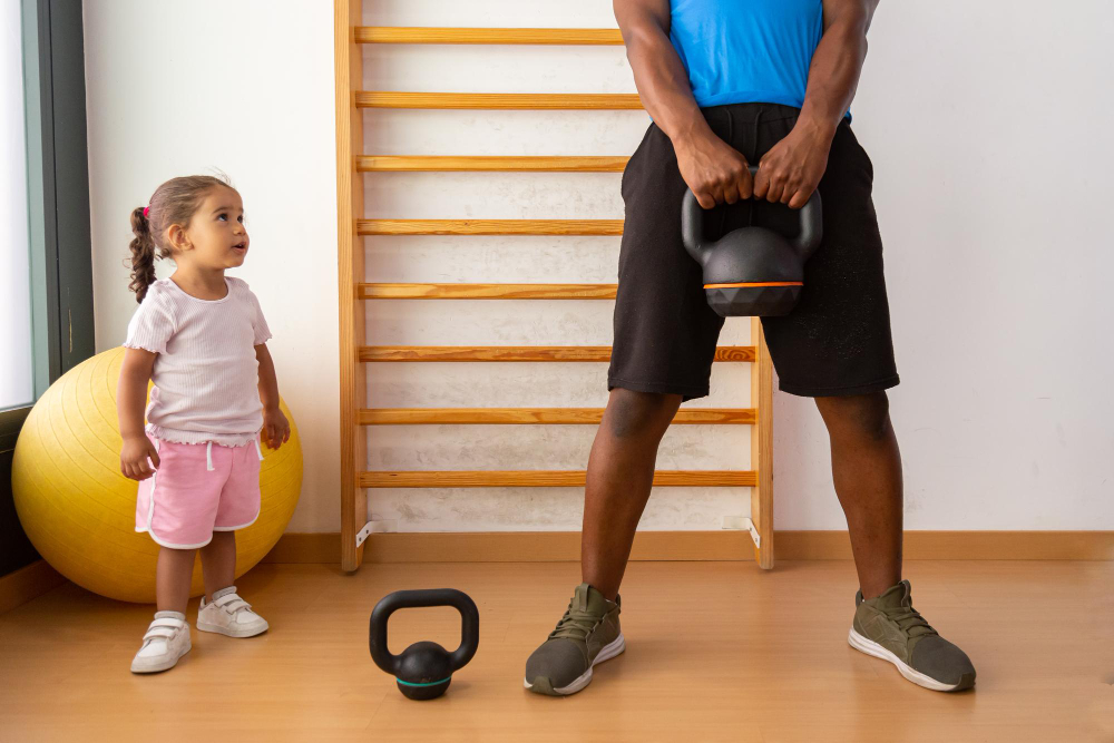 Father lifting kettlebell with his daughter
