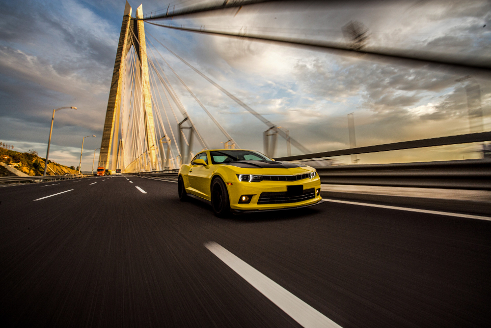 Free photo yellow sport car with black autotuning on the bridge.
