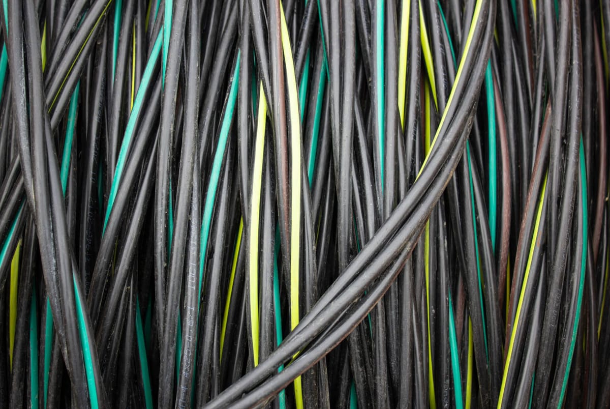 Reel with electric cable. Coil of electrical industrial wire, cable.Cable wire winding. Coiled insulated cable, background.