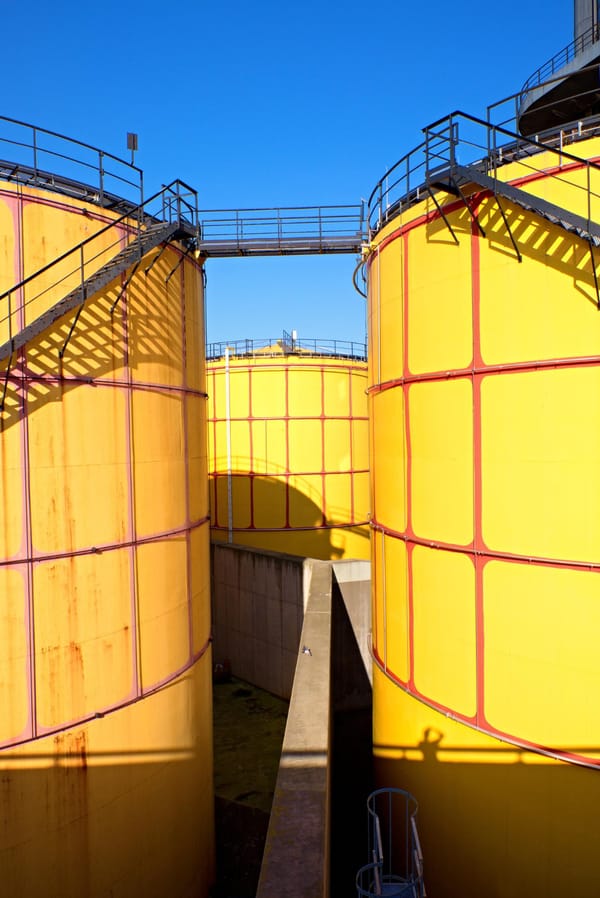 Tanks in powerplant old kind of factory plant metal construction with old yellow paint and rust