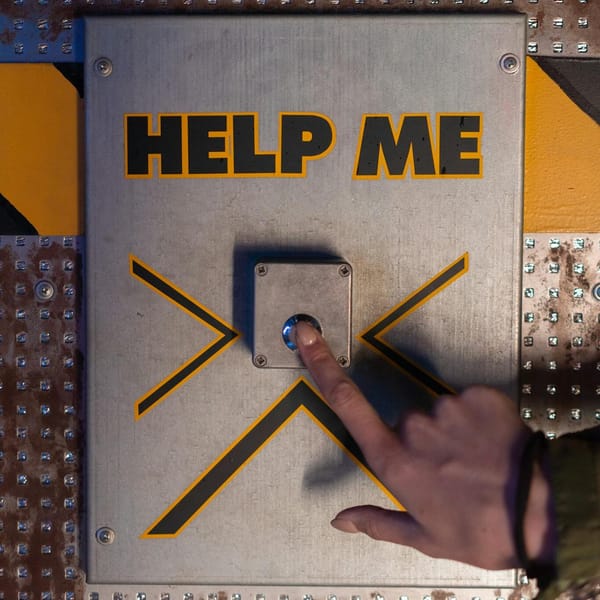 A hand presses an emergency 'help me' button on a metallic panel, evoking sci-fi themes.