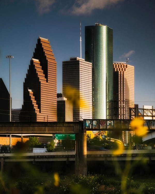 Capture of Houston's downtown skyline at sunset, showcasing modern architecture.