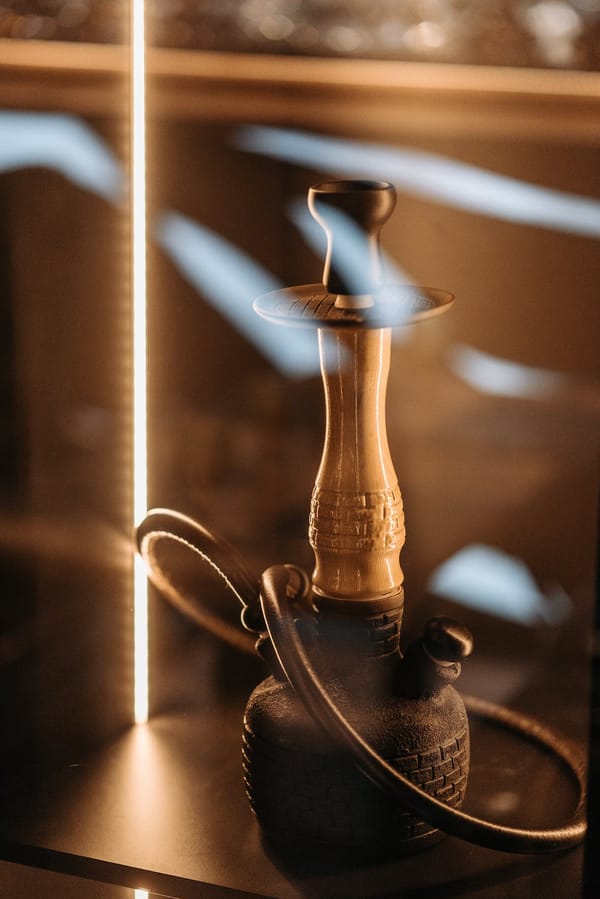 Brass and Black Hookah on Brown Wooden Table