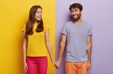 Romantic couple in love have date, hold hands, look positively at each other