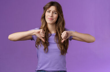 Disappointed displeased pity girl show thumbs down grimace dislike express negative opinion thumbs down gesture