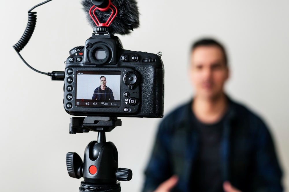 Blogger recording a video for YouTube. How to make YouTube automation work for you.