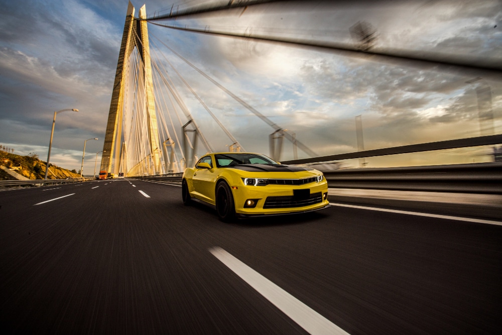Free photo yellow sport car with black autotuning on the bridge. 