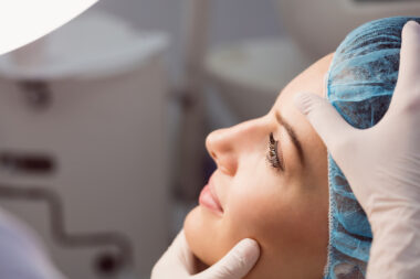Free photo doctor examining womans face for cosmetic treatment