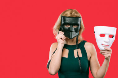 Woman covering face with black mask