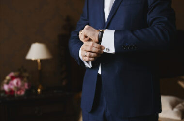 Photo close view of the luxury watches on the hand of a businessman in a suit and in a shirt with cufflinks.