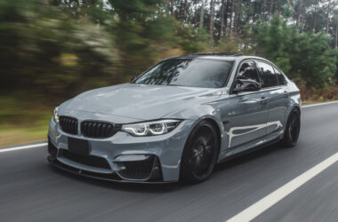 silver metallic color sport sedan on the road.