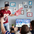 group of friends watching football at home