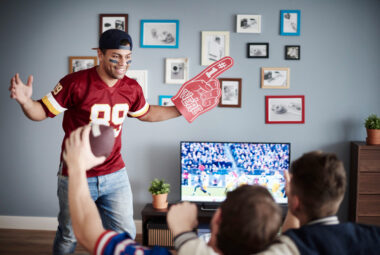 group of friends watching football at home