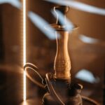 Brass and Black Hookah on Brown Wooden Table