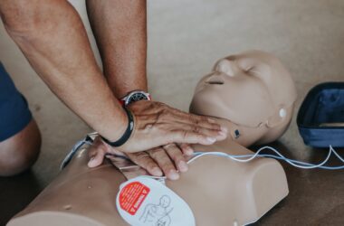 Hands of Person Doing CPR on Training Dummy