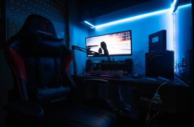 Desktop Computer with Speakers and Gaming Chair in a Room with Blue Light