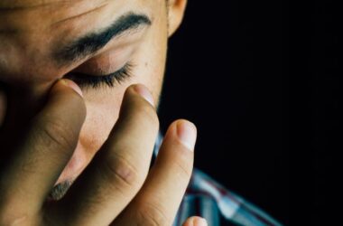 Man Pinching Nose Close-up Photo
