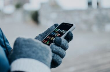 Person Wearing Gloves Holding a Cellphone