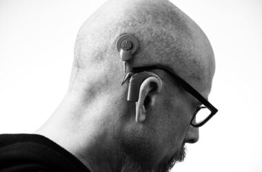 Grayscale Photo of a Man with a Hearing Aid