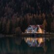 White and Red House Surrounded by Trees at Night