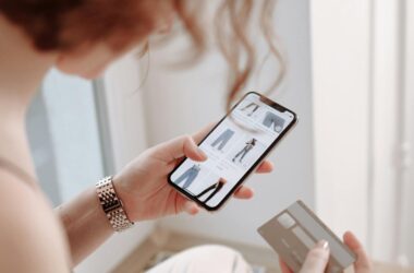 A woman using a smartphone for online shopping, holding a credit card.