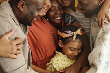 Heartwarming family group hug showcasing affection and togetherness indoors.