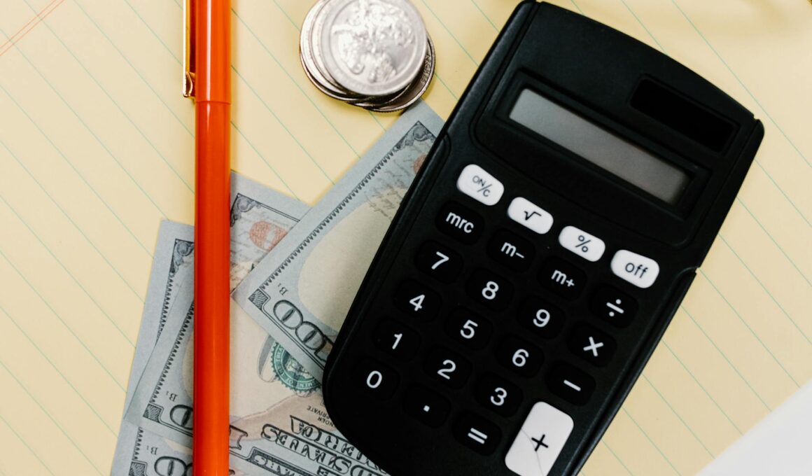 Close-up image of a calculator, pen, and currency on a yellow notepad, symbolizing finance.