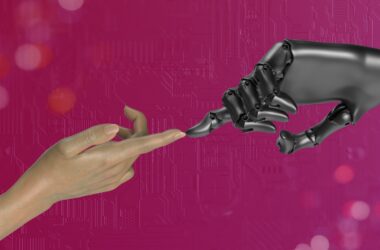 two hands touching each other in front of a pink background